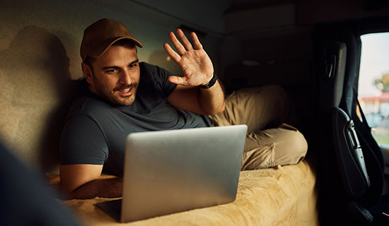 Man waving to laptop