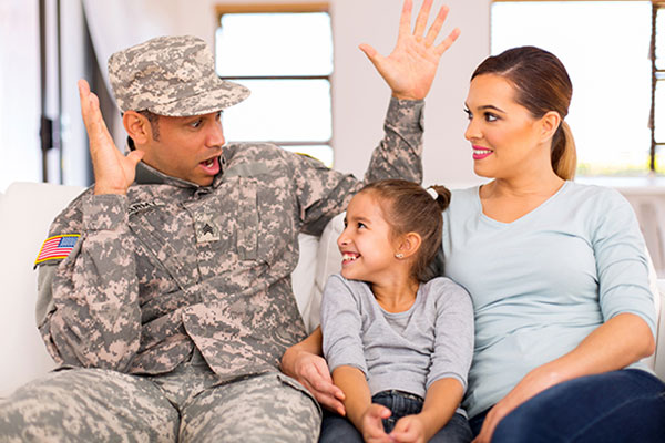Soldier with woman and child sitting on a couch